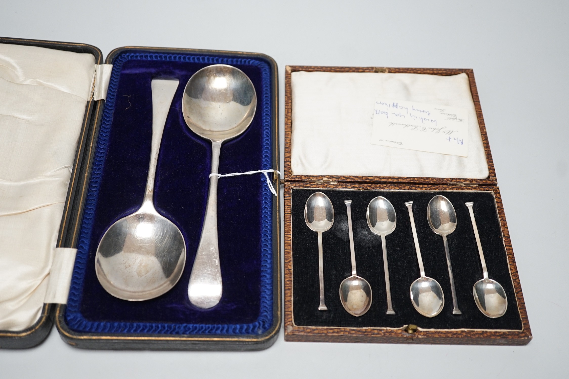 A set of six George V silver seal top coffee spoon, cased, and a pair of George V silver old English pattern fruit spoons, Sheffield, 1916, cased.